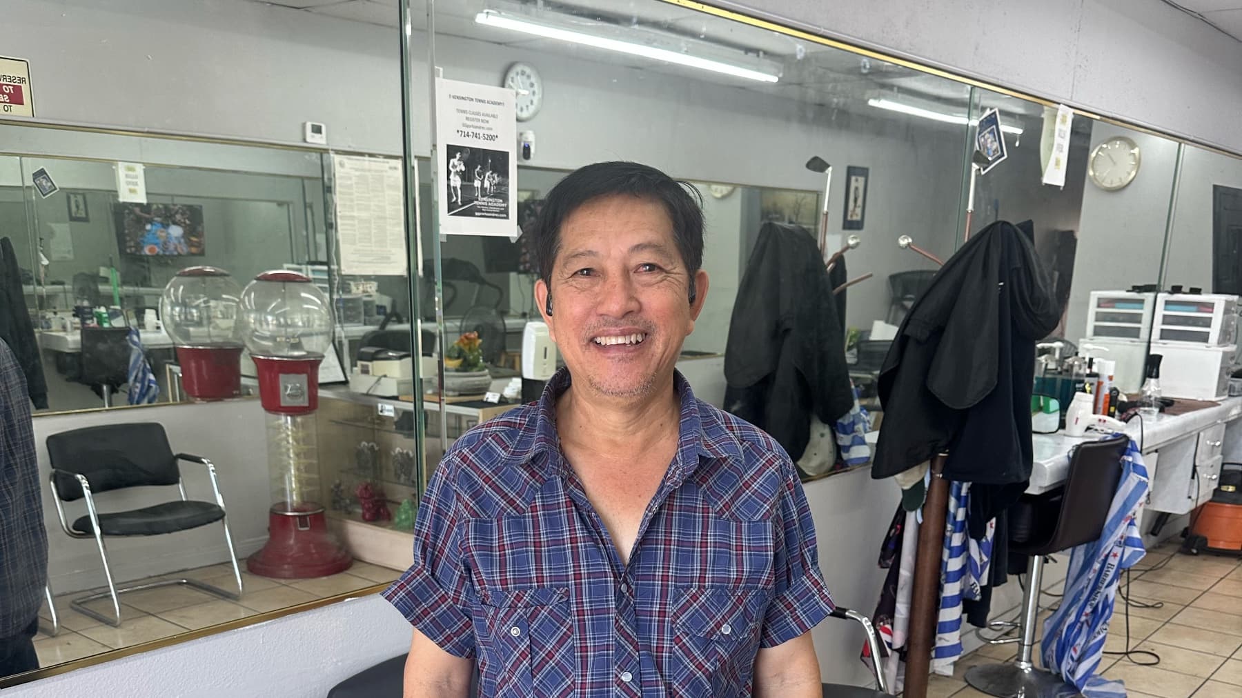 John, the barber at John's Barber Shop on Knott Ave in Anaheim, standing in his shop